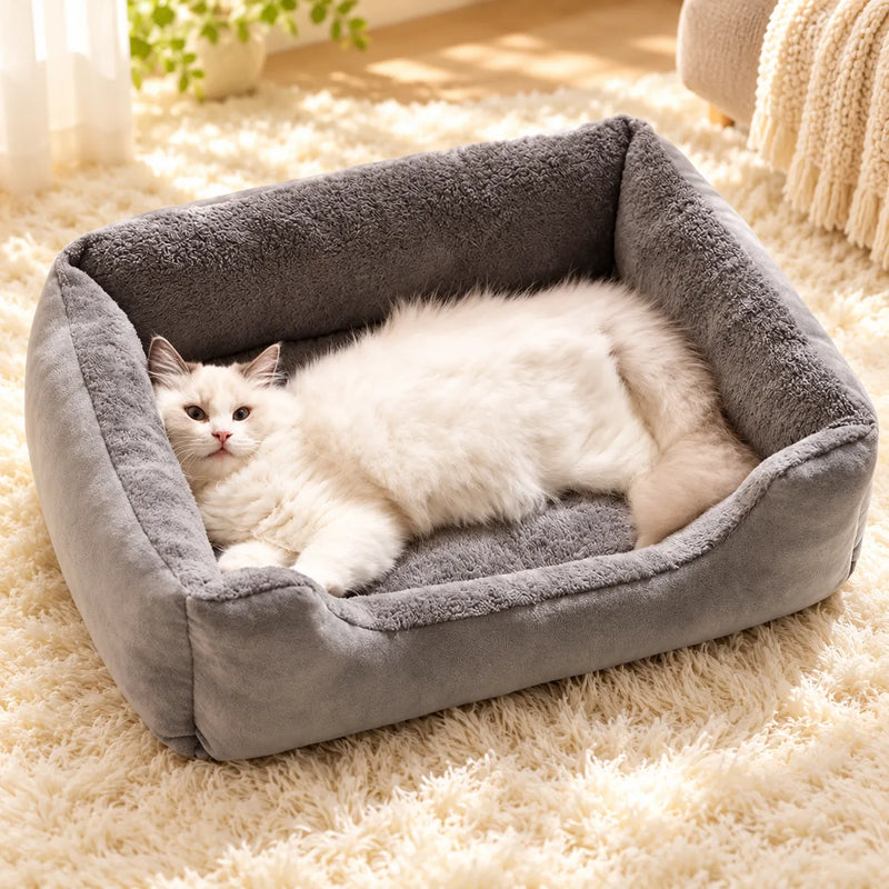 White cat lying in the gray Plush Winter Cat Bed on a cream rug