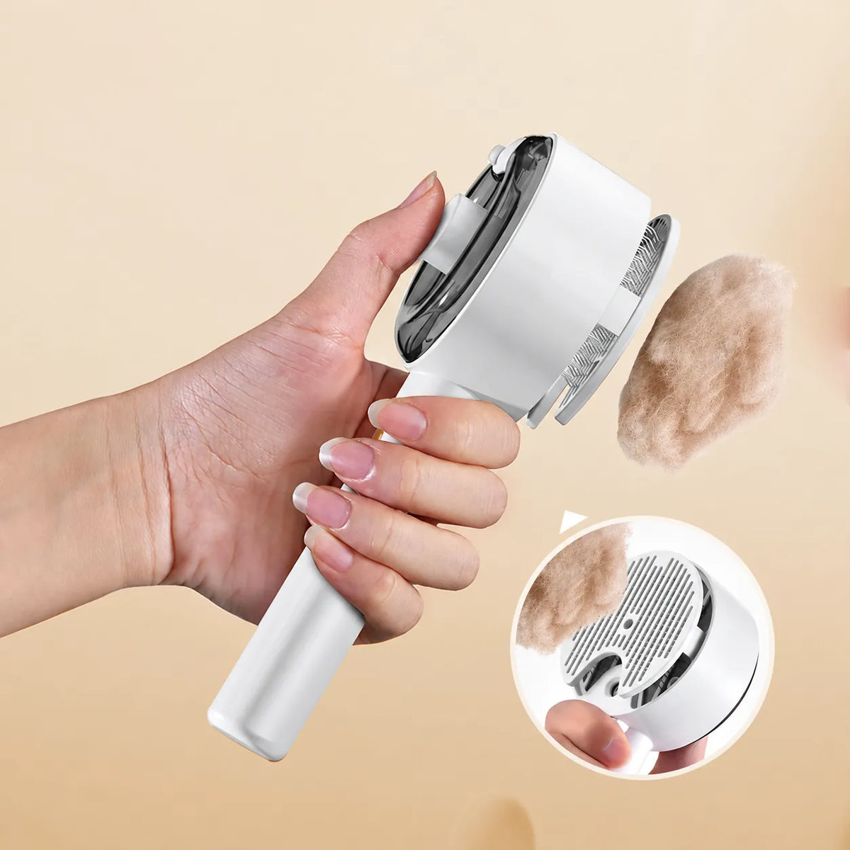 Hand releasing collected fur from the Mist Grooming Brush head