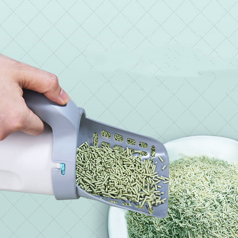 Scooping clumps from a litter box with the Litter Scoop with Storage
